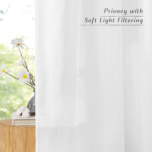 White linen look sheer curtains providing soft light filtering and privacy, hanging by a sunny window.