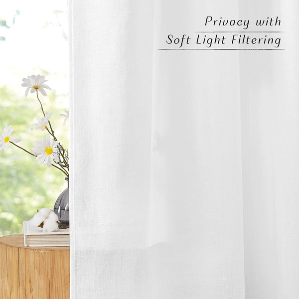 White linen look sheer curtains providing soft light filtering and privacy, hanging by a sunny window.