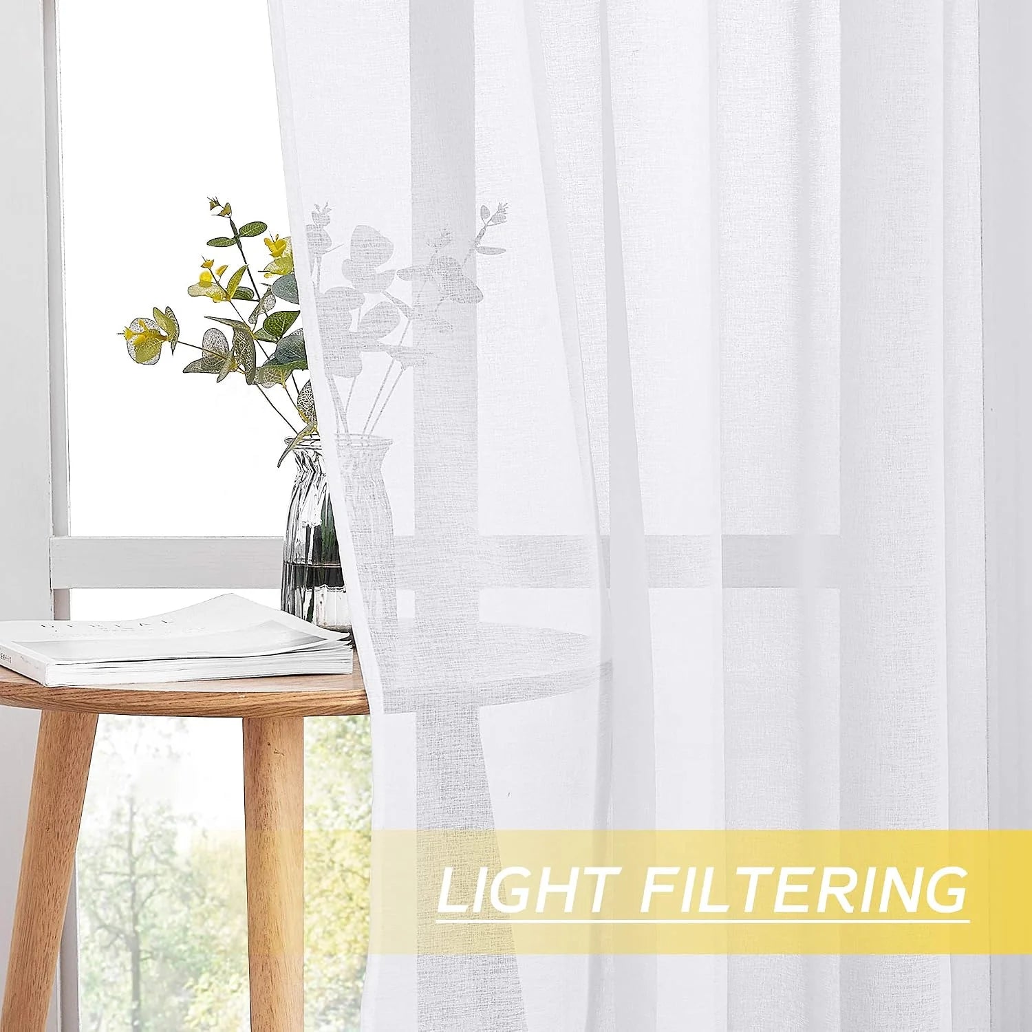 White sheer linen-look curtain filtering light by a bright window with wood table