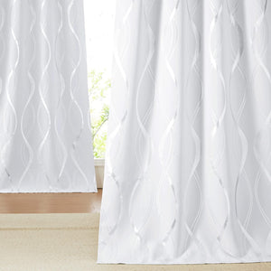 White light filtering curtain panels display a vertical metallic silver wave pattern.