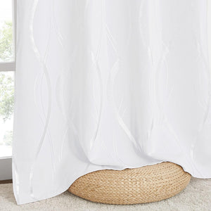 White modern curtain panel with shimmering silver abstract wavy lines, elegantly draped over a woven pouf.