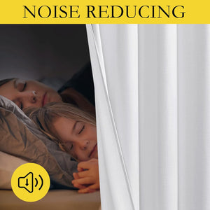 White noise-reducing curtains drawn, providing a dark and quiet bedroom for a sleeping mother and child.