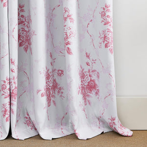 White curtain with a detailed pink and light pink toile floral and botanical pattern, softly draped.
