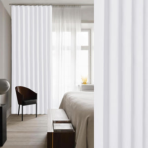 White pleated track curtains creating a modern room divider in a bright, minimalist bedroom setting.
