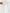 Close-up of a white rod pocket curtain hanging on a wooden rod, suitable for a 2-inch diameter rod. The fabric has a smooth, soft drape.