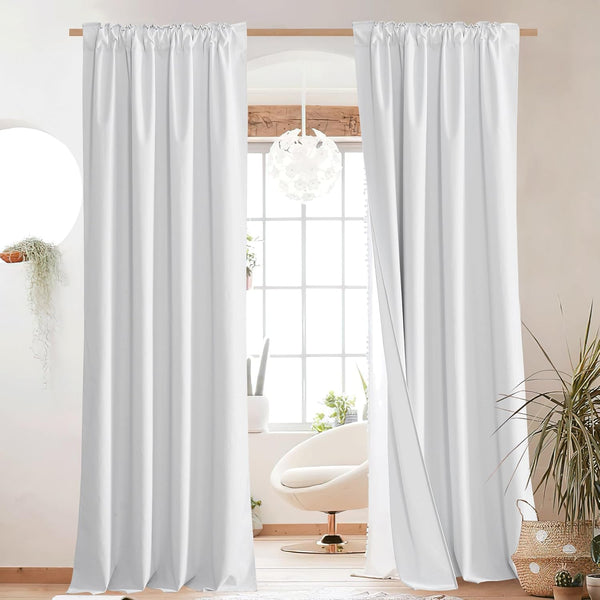 White rod pocket curtains hanging on a light wooden rod, showing a slight gather. Solid drapes provide privacy.