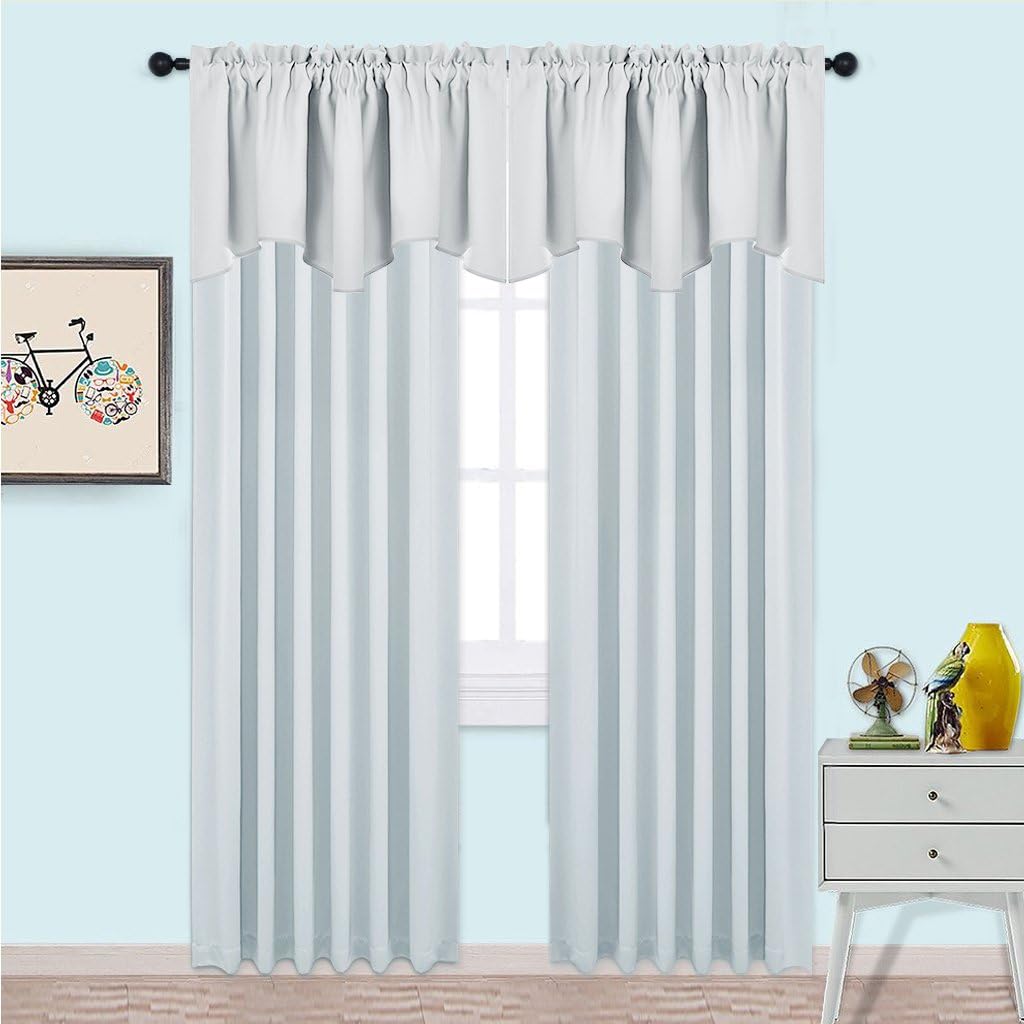 White semi-sheer rod pocket curtains with a matching scalloped valance hung over a window.