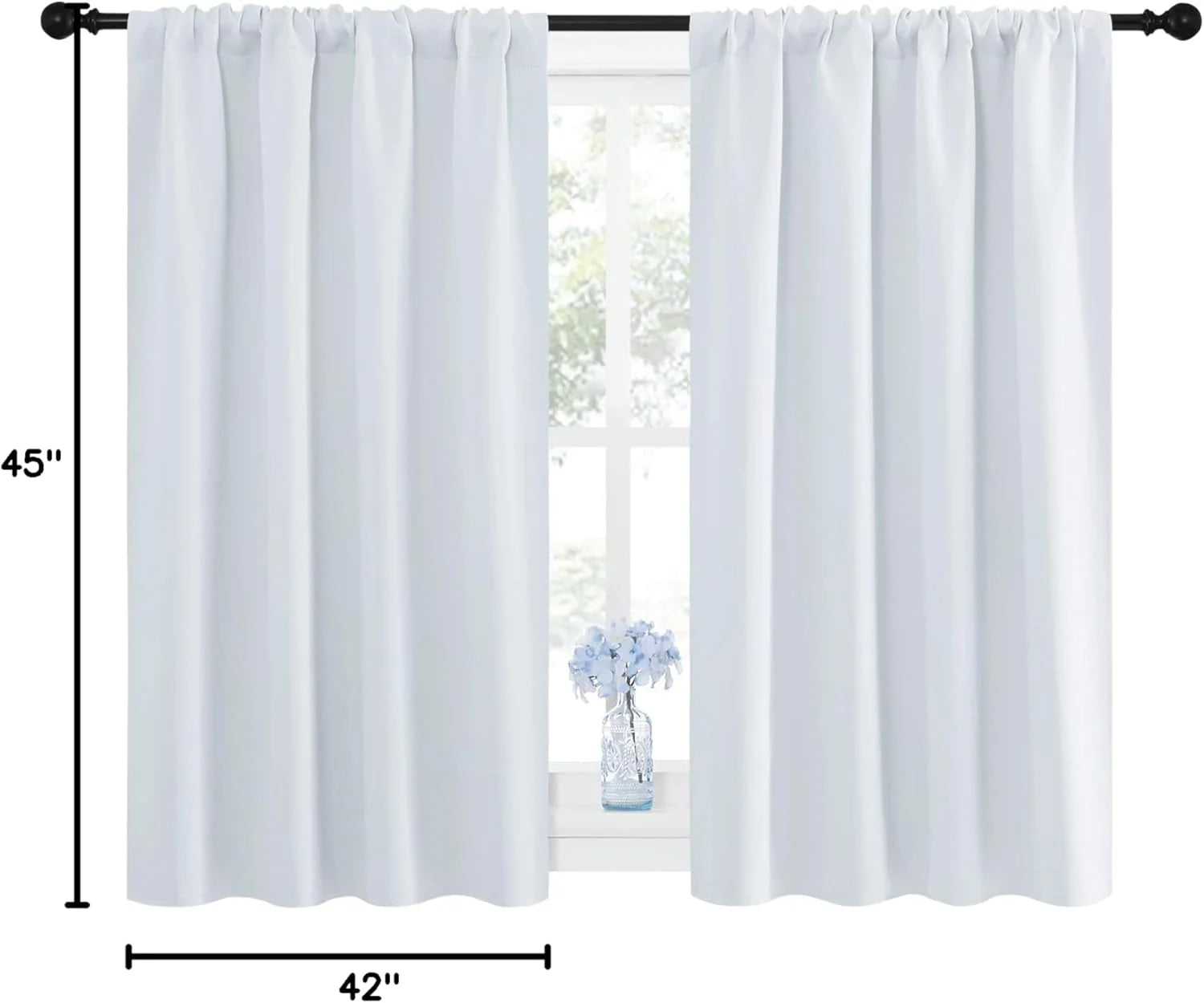 White rod pocket curtains on a black curtain rod over a bright window