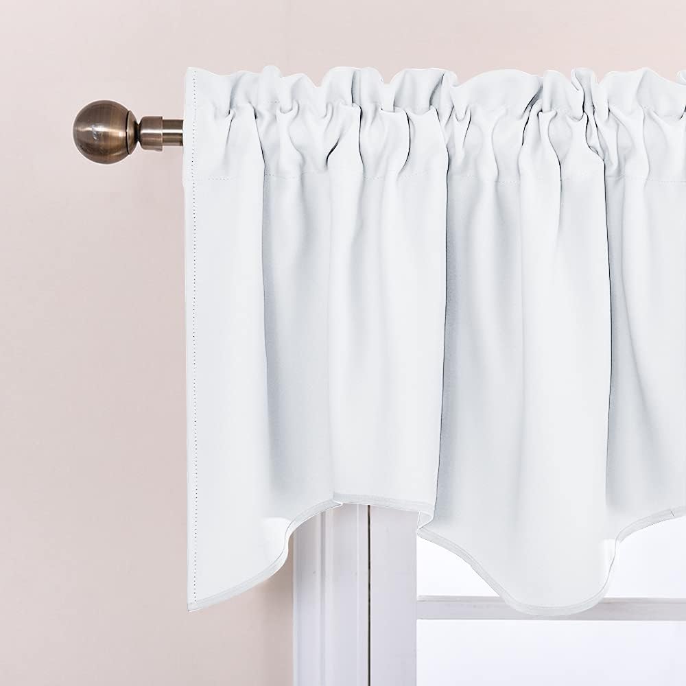 White ruffled rod pocket window valance with a scalloped bottom edge, hung on a bronze curtain rod.