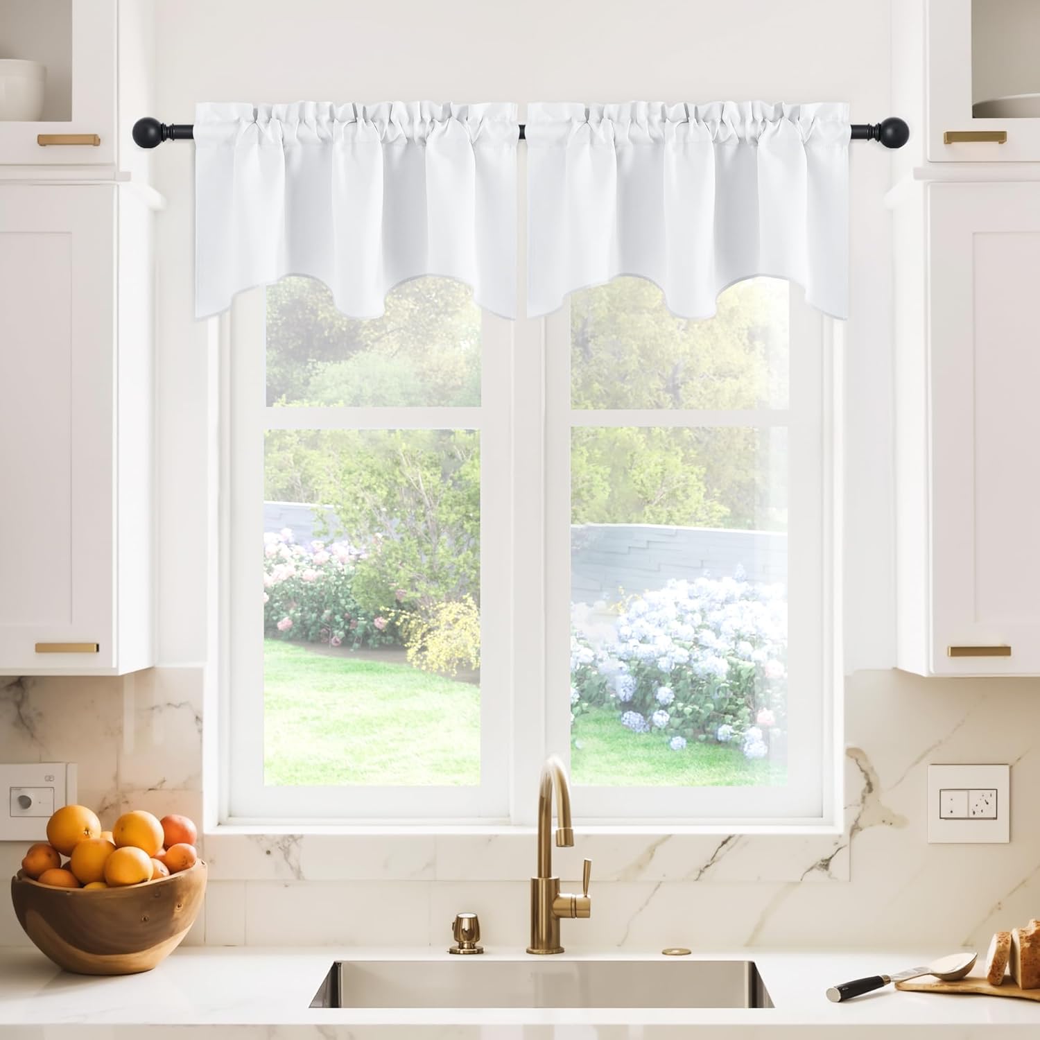 White scalloped valance curtain with a gathered rod pocket top, hanging over a kitchen window.