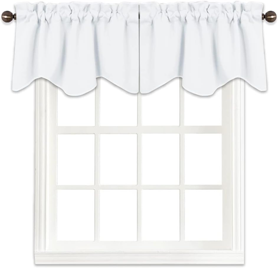 White fabric valance with scalloped bottom edge and gathered rod pocket, hanging on a dark rod.