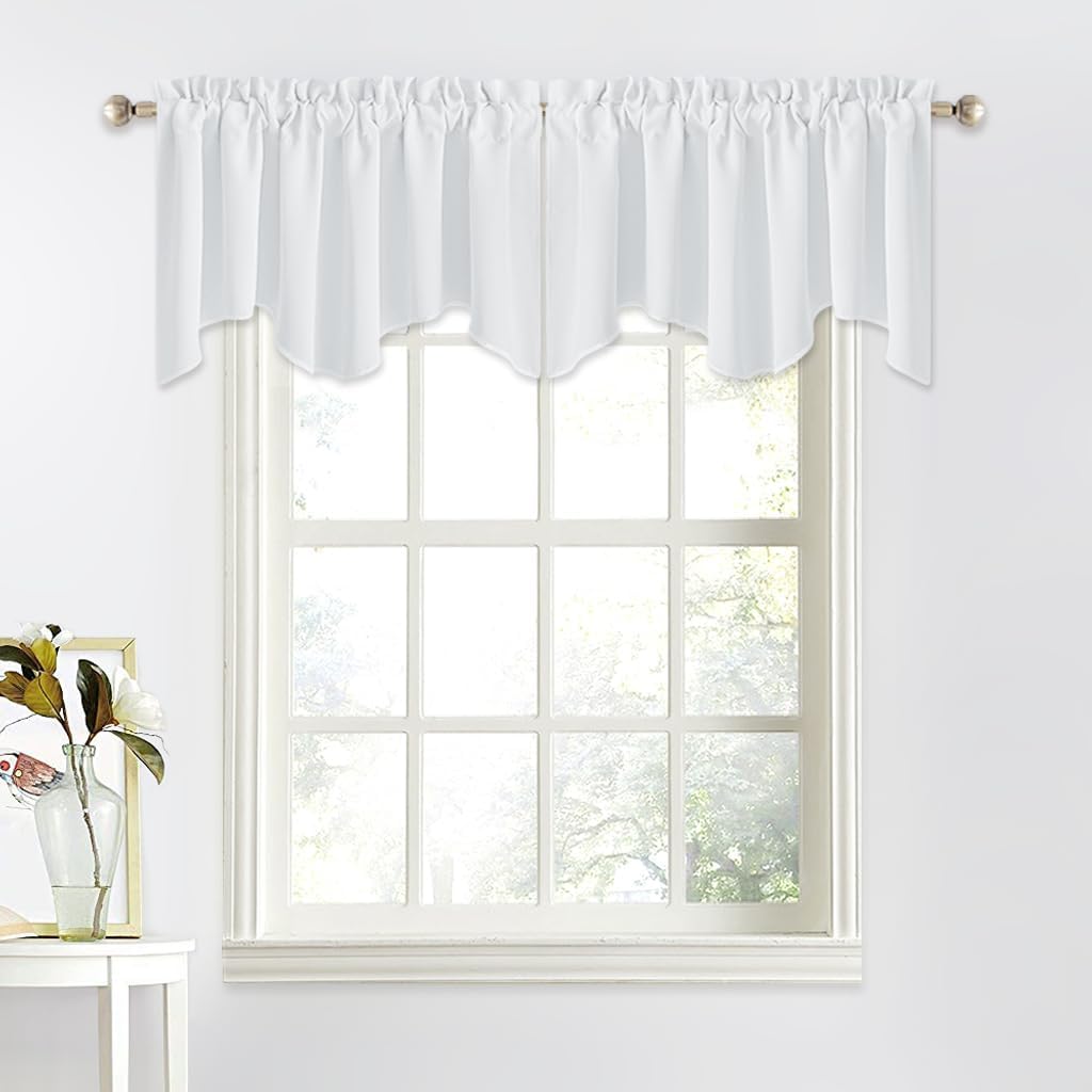 White scalloped rod pocket valance with gathered top on a brushed metal rod over a multi-pane window.
