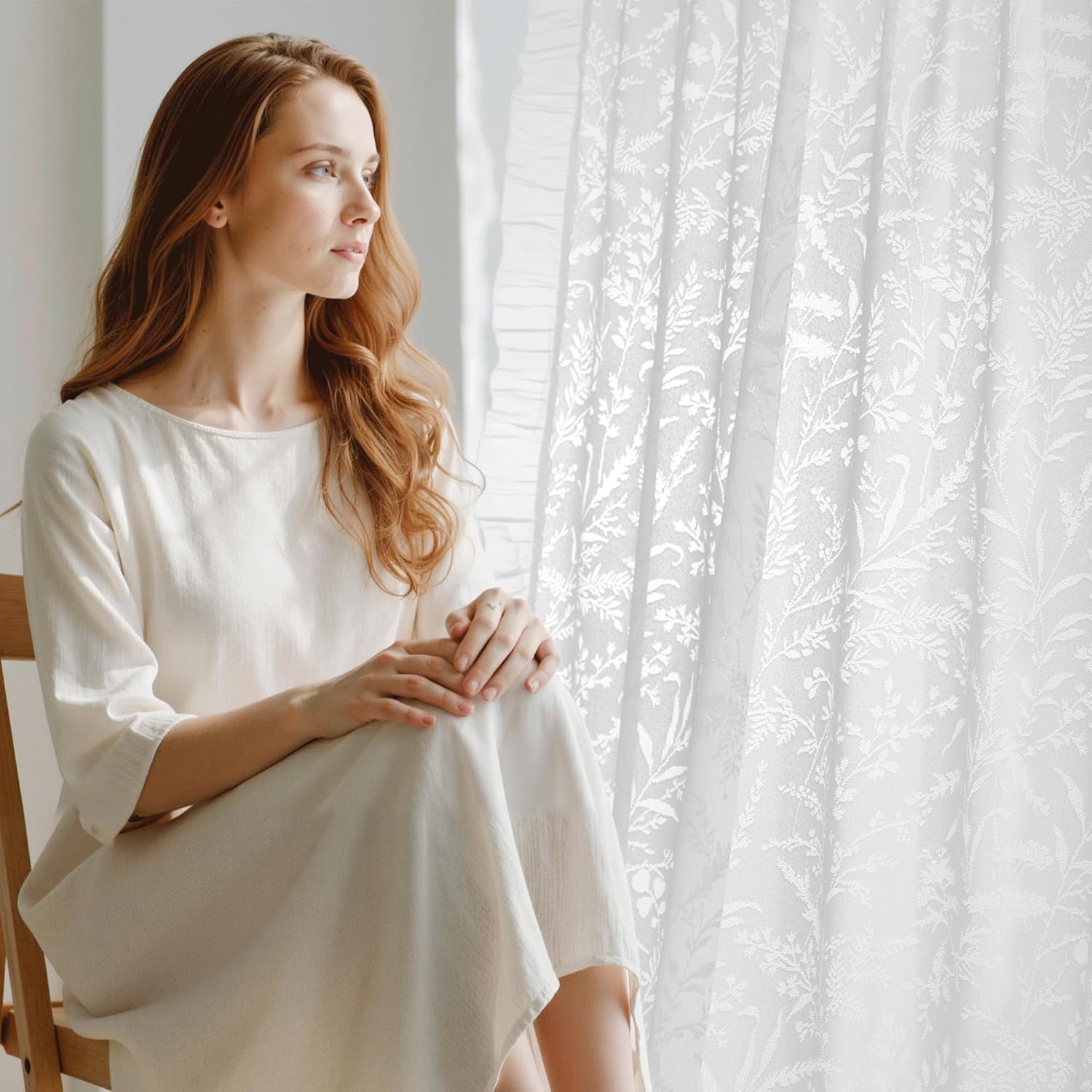White sheer window curtain featuring an intricate embroidered botanical leaf pattern, softly diffusing light.