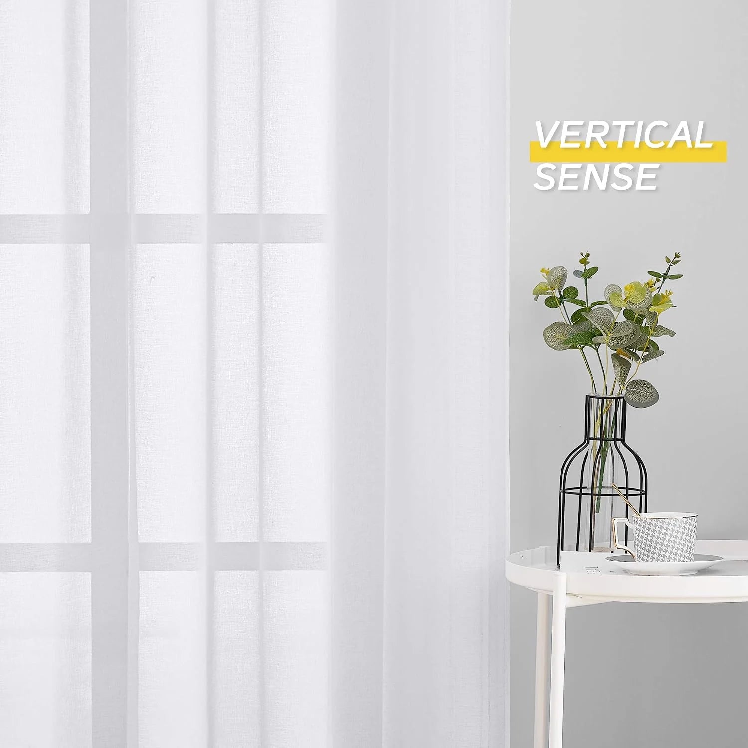 White sheer linen-look curtain filtering light beside a small table with vase