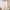 Pair of white sheer linen tie-top curtains hang on a wooden rod, softly diffusing light through a window.