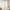 Two panels of white sheer linen tie-top curtains on a wooden rod, softly filtering light.