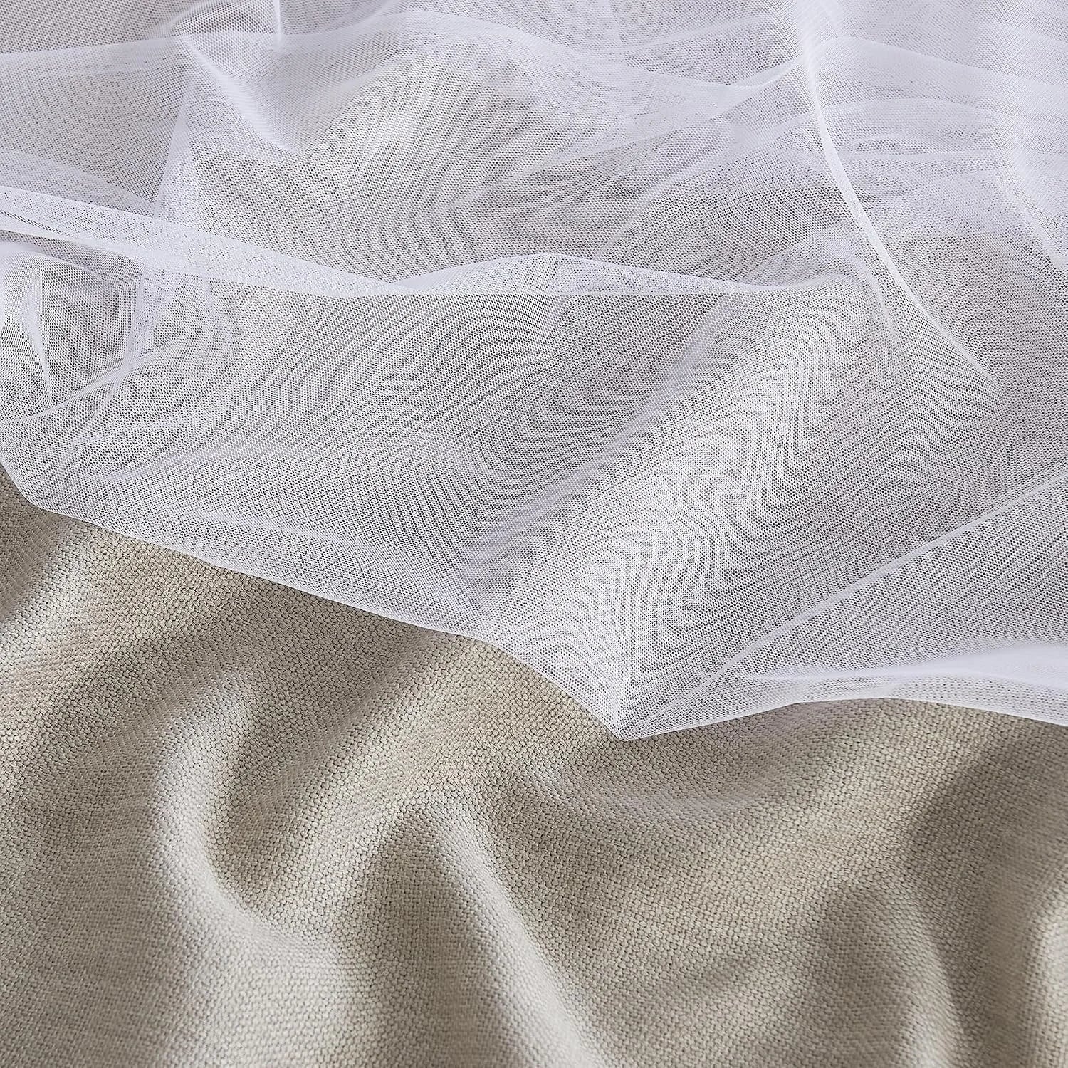 White sheer mesh fabric draped over beige textured linen in a soft close-up