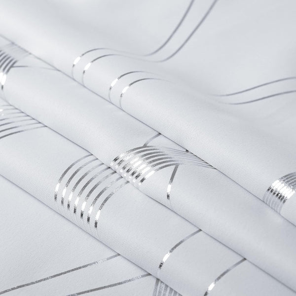White woven fabric with shimmering silver metallic stripes. The folds create an intersecting geometric pattern.