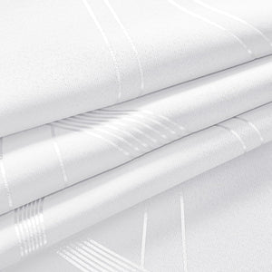 White woven fabric with shiny silver geometric stripes, softly folded to highlight its reflective pattern.