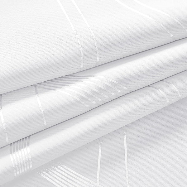 White woven fabric with shiny silver geometric stripes, softly folded to highlight its reflective pattern.