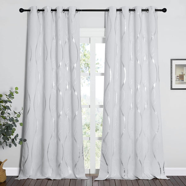 Modern white panel curtains with shimmering silver wavy pattern and silver grommet tops on a black rod.