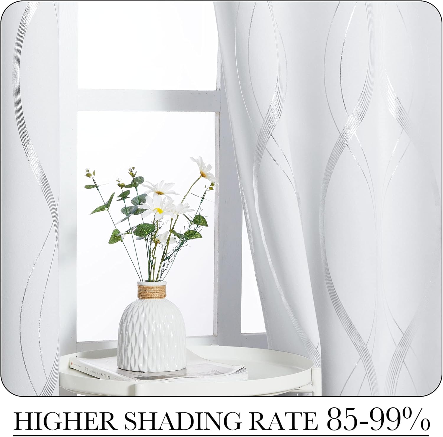 White blackout curtains with shimmering silver wavy lines hanging elegantly in a bright window.