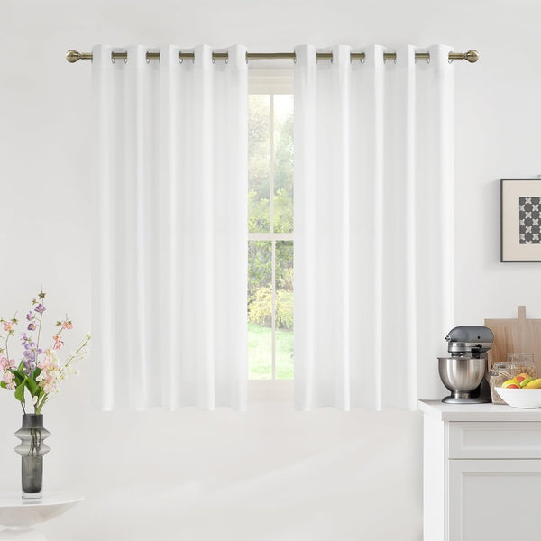 Pair of white solid curtain panels with bronze grommet tops hung on a rod over a window.