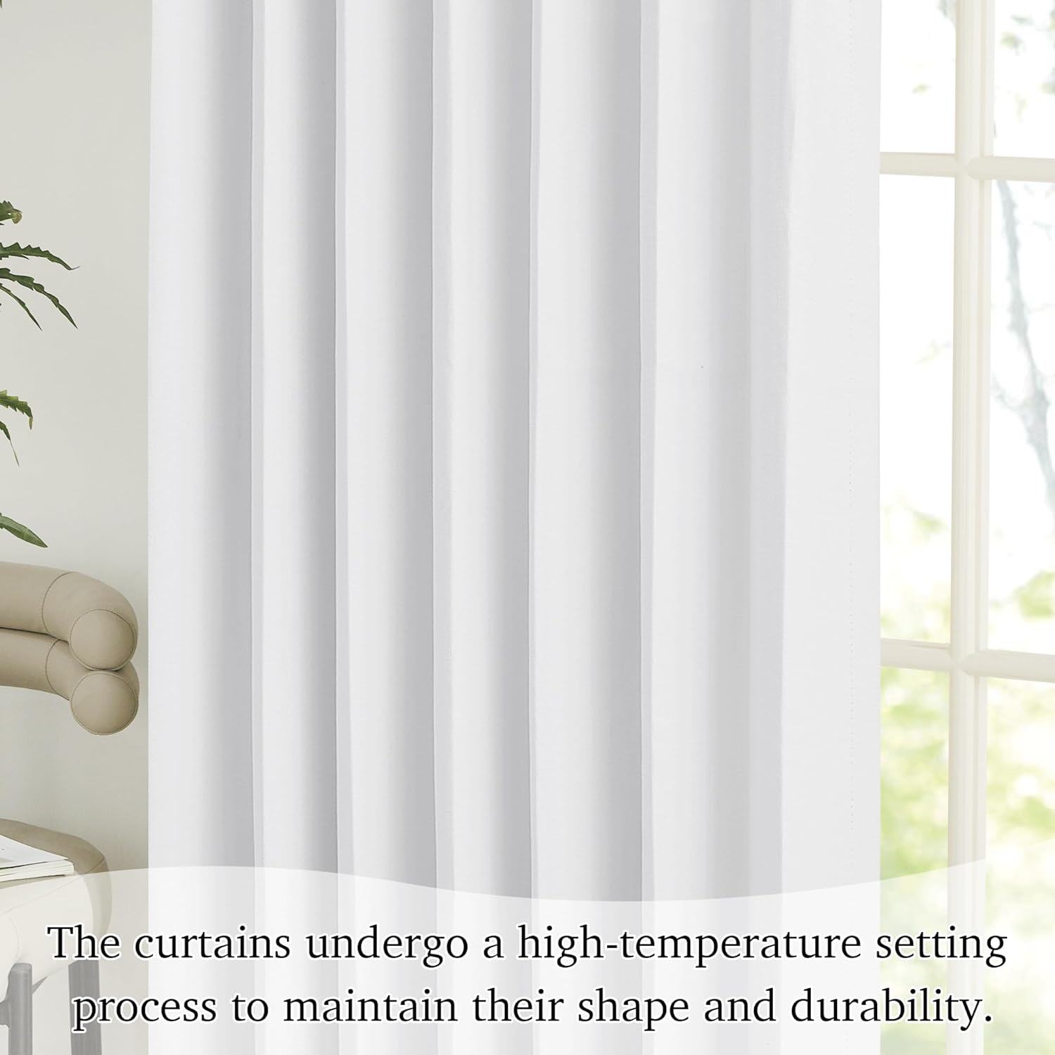 Bright white solid curtain panel with neat vertical pleats hanging in front of a window.