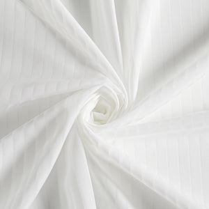 Close-up of elegant white sateen fabric with subtle vertical stripe texture, artfully twisted into a spiral.