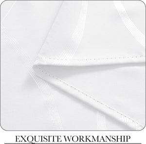 Detailed view of white fabric with elegant textured stripe pattern, featuring impeccable, precise stitching on the hem.