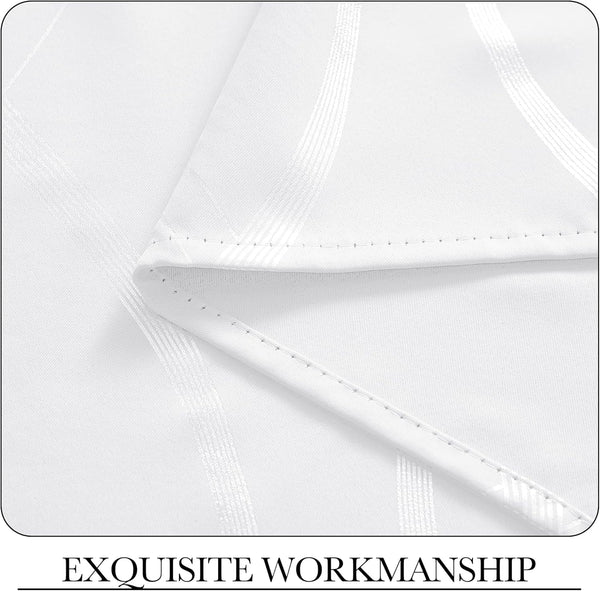Detailed view of white fabric with elegant textured stripe pattern, featuring impeccable, precise stitching on the hem.