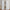 White tab top linen blend curtains hanging on a wooden rod, gently pooling on a wooden floor.