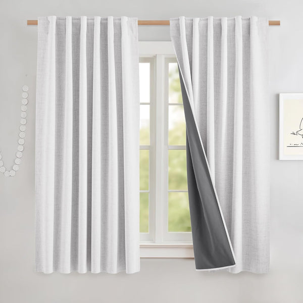 White textured curtain panels with dark grey blackout lining visible, hanging on a wooden rod.