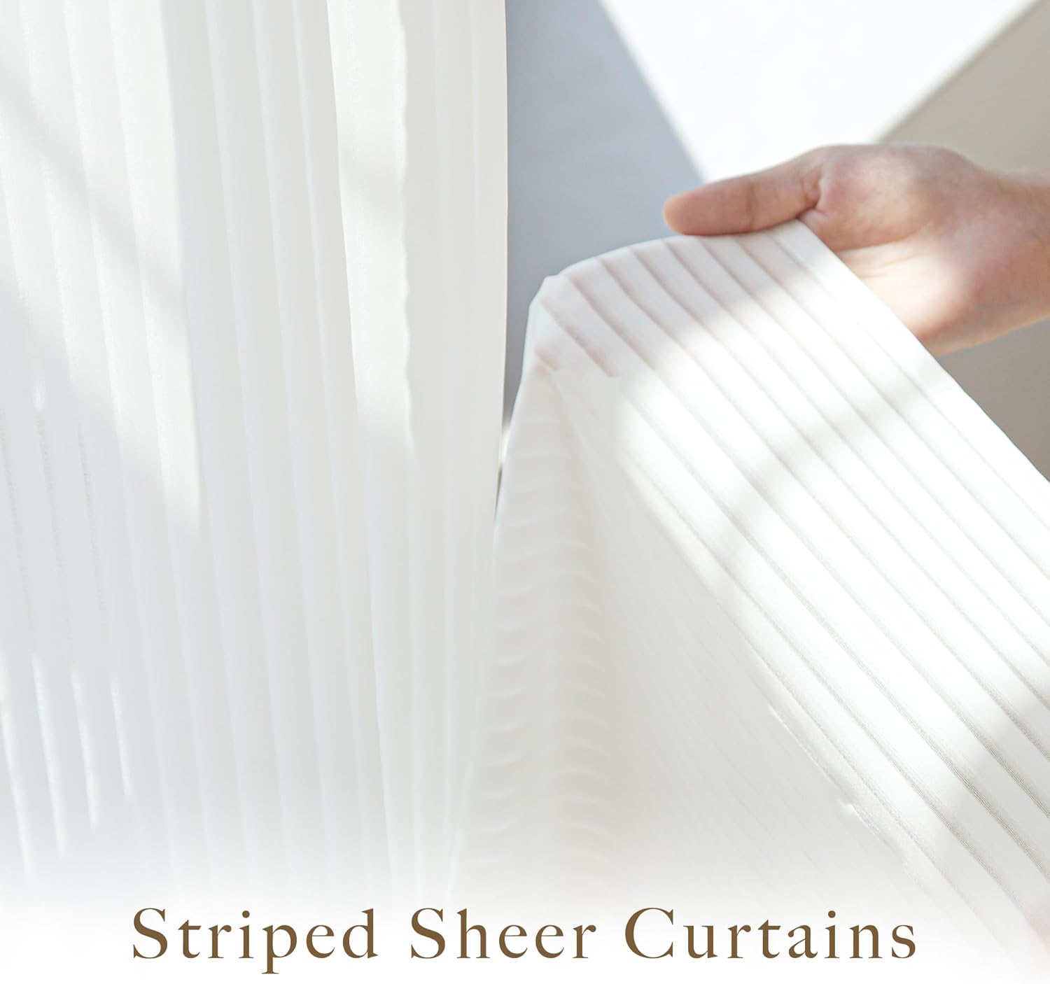Hand holding a white sheer curtain with vertical stripes, showcasing its light filtering fabric.