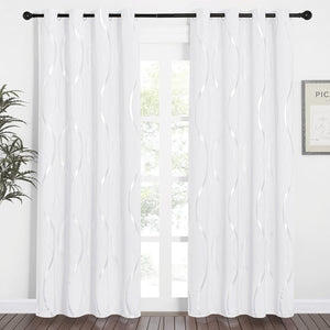 White curtains with shimmering wavy metallic pattern and silver grommet tops.
