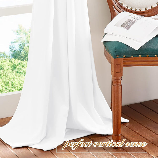 White solid window curtain with elegant vertical drape, reaching wooden floor. Classic wooden chair visible.
